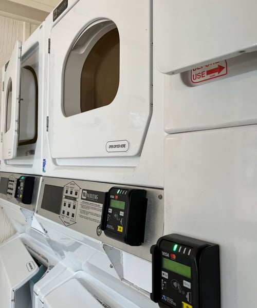 Commercial dryer machines with card readers.